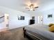 Spacious carpeted main bedroom with TV, dresser, and ensuite bathroom at 4190 Bull St, St Cloud, FL 34772