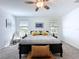 Bright main bedroom with a ceiling fan, carpet, and large windows at 4190 Bull St, St Cloud, FL 34772
