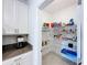 Bright pantry features white wire shelving for organized storage, conveniently located near the kitchen at 4190 Bull St, St Cloud, FL 34772