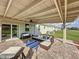 Covered outdoor patio with stylish seating and a ceiling fan for relaxation at 4190 Bull St, St Cloud, FL 34772
