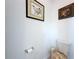 Small toilet room with decorative artwork on the walls at 4190 Bull St, St Cloud, FL 34772