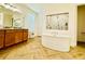 Elegant bathroom showcasing a standalone tub, granite countertops and walk-in shower at 5019 Down Ct, St Cloud, FL 34772