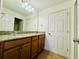 Bathroom with wood cabinets, granite counters, and tiled floors offer a modern, clean design at 5019 Down Ct, St Cloud, FL 34772