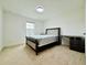 Spare bedroom with a black bed and an adjustable desk at 5019 Down Ct, St Cloud, FL 34772