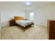 Neutral bedroom with a wood bed, dresser, and a view from the window at 5019 Down Ct, St Cloud, FL 34772