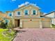 Charming home with a brick driveway, a three-car garage, and beautiful stone accents at 5019 Down Ct, St Cloud, FL 34772