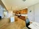 Spacious kitchen with wood cabinets, granite countertops, and herringbone-patterned tile floors at 5019 Down Ct, St Cloud, FL 34772