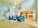 Spacious open concept living room with tile flooring and view of the kitchen and staircase at 5019 Down Ct, St Cloud, FL 34772
