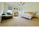 Bright primary bedroom with a chair, dresser, bedside tables and lamps at 5019 Down Ct, St Cloud, FL 34772