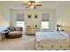 Light primary bedroom featuring a chair, dresser, and bedside tables with lamps at 5019 Down Ct, St Cloud, FL 34772