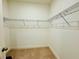 Empty walk-in closet showing metal shelving and carpeted flooring at 5019 Down Ct, St Cloud, FL 34772
