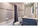 Bathroom with tiled shower and tub combo, sleek vanity, and modern fixtures at 5414 Log Grove Ln, Orlando, FL 32829