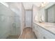 Bright bathroom with a glass-enclosed shower, double vanity, and stylish finishes, creating a spa-like retreat at 5414 Log Grove Ln, Orlando, FL 32829