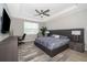 Modern bedroom featuring a king-size bed, desk area, and serene natural light, designed for ultimate relaxation at 5414 Log Grove Ln, Orlando, FL 32829