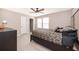 Well-lit bedroom featuring a patterned bedspread, dresser, and an ensuite closet at 5414 Log Grove Ln, Orlando, FL 32829