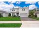 Charming two-story home boasts manicured lawn, brick-paved driveway, and a two-car garage at 5414 Log Grove Ln, Orlando, FL 32829
