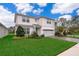 Charming two-story home boasts manicured lawn, brick-paved driveway, and a two-car garage at 5414 Log Grove Ln, Orlando, FL 32829