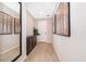 Bright foyer features wood-look floors, mirror and art, leading to the front door at 5414 Log Grove Ln, Orlando, FL 32829