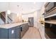 Modern kitchen with an island, stainless appliances, and bright lighting at 5414 Log Grove Ln, Orlando, FL 32829