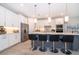 Spacious kitchen features a large center island with pendant lighting and stainless appliances at 5414 Log Grove Ln, Orlando, FL 32829