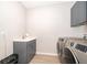 Functional laundry room with stainless steel washer and dryer, plus ample counter and cabinet space at 5414 Log Grove Ln, Orlando, FL 32829