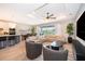 Bright living room with modern decor, featuring a large sectional sofa and access to the outdoor patio at 5414 Log Grove Ln, Orlando, FL 32829