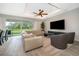 Cozy living room showcasing a comfortable sectional, large windows, and seamless indoor-outdoor living at 5414 Log Grove Ln, Orlando, FL 32829