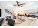 Open-concept living room flowing into the kitchen and dining area, with hardwood floors and modern decor at 5414 Log Grove Ln, Orlando, FL 32829