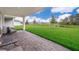 Covered patio overlooking a well-manicured lawn, pond, and neighborhood view at 5414 Log Grove Ln, Orlando, FL 32829