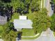 Aerial view of the home with mature trees, showcasing its roof, backyard, and surrounding neighborhood at 5464 Windridge Ln, Orlando, FL 32810