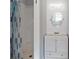 Bathroom featuring a shower, vanity with sink, and decorative oval mirror at 5464 Windridge Ln, Orlando, FL 32810