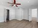 A bedroom with wood floors, a ceiling fan, and multiple doors at 5464 Windridge Ln, Orlando, FL 32810