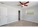 Bedroom showcasing light wood floors, neutral walls, and a closet at 5464 Windridge Ln, Orlando, FL 32810