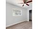 A bedroom with light wood floors, a ceiling fan, and a window at 5464 Windridge Ln, Orlando, FL 32810