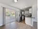 Bright kitchen with stainless steel appliances and sliding glass door to the screened porch at 5464 Windridge Ln, Orlando, FL 32810