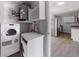 Laundry area with washer, dryer, and view into a spacious kitchen at 5464 Windridge Ln, Orlando, FL 32810
