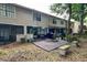 Townhome backyard with a wood deck, seating, lush landscaping, and the building's exterior at 554 Northbridge Dr, Altamonte Springs, FL 32714