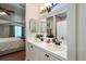 Bright bathroom with double vanity sinks, a tile shower, and an adjoining bedroom at 554 Northbridge Dr, Altamonte Springs, FL 32714
