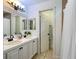 Bathroom featuring a double sink vanity with black faucets and a doorway to a separate toilet area at 554 Northbridge Dr, Altamonte Springs, FL 32714