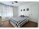 Bright bedroom featuring a window with curtains, carpet, and a checkered bedspread at 554 Northbridge Dr, Altamonte Springs, FL 32714