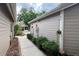 Exterior side view with walkway and low-maintenance landscaping and flower beds at 554 Northbridge Dr, Altamonte Springs, FL 32714