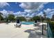 Outdoor pool with tables and umbrellas set up with trees in the surrounding area at 554 Northbridge Dr, Altamonte Springs, FL 32714