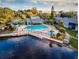 Aerial view showcasing the community pool, lake, and surrounding lush landscape at 6040 Peregrine Ave # A01, Orlando, FL 32819