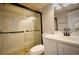 A clean bathroom featuring a shower with glass doors and updated fixtures at 6040 Peregrine Ave # A01, Orlando, FL 32819