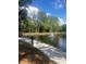 Scenic community lake with a fountain, surrounded by a lush green landscape at 6040 Peregrine Ave # A01, Orlando, FL 32819