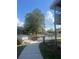 Beautiful community view featuring a private lake and mature trees at 6040 Peregrine Ave # A01, Orlando, FL 32819