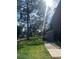 Lush green community with mature trees and manicured lawns along a walkway at 6040 Peregrine Ave # A01, Orlando, FL 32819