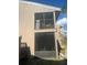 Exterior of home features a screened in porch on each floor and a small tree at 6040 Peregrine Ave # A01, Orlando, FL 32819