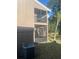 Exterior of home features a screened in porch on each floor and a small tree at 6040 Peregrine Ave # A01, Orlando, FL 32819