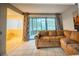 A spacious living room with tile floors features sliding glass doors leading to an outdoor patio at 6040 Peregrine Ave # A01, Orlando, FL 32819